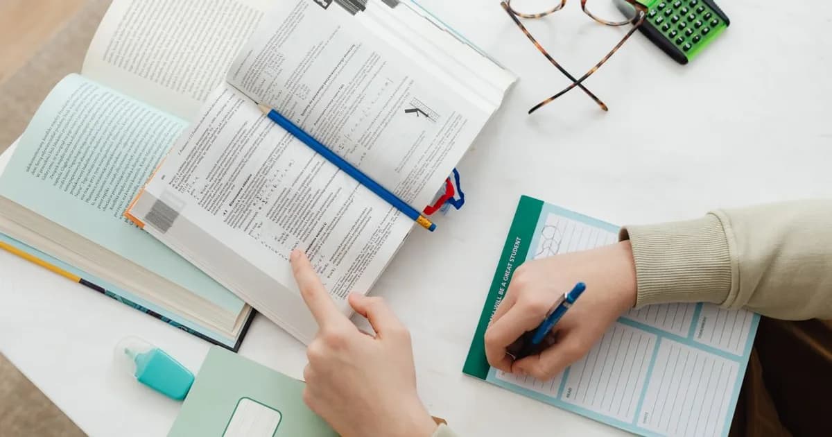 Adult studying Australian citizenship booklet and notes at a desk