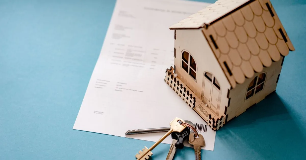 House keys and real estate closing documents on a table