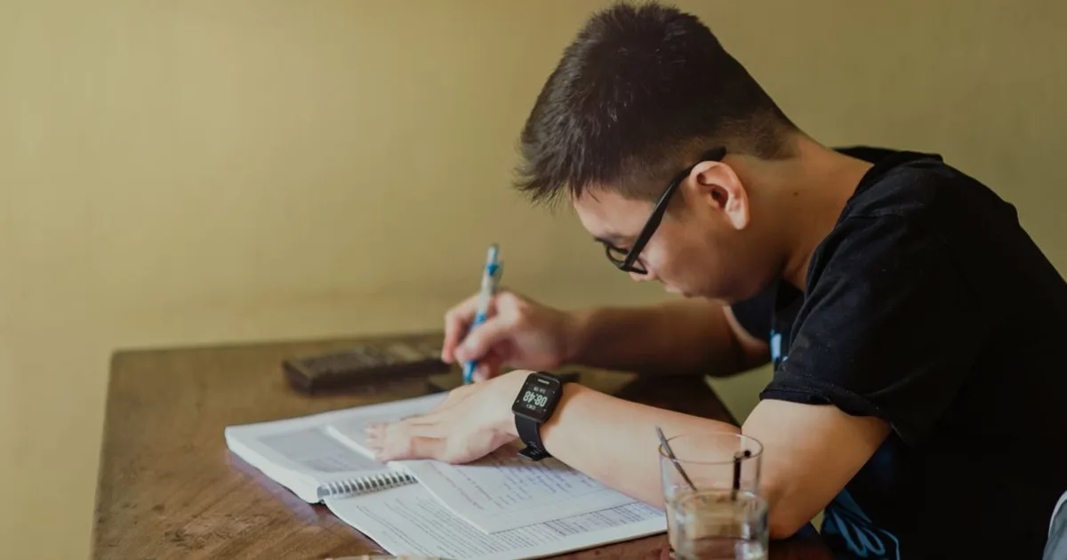 Adult studying a commercial driver handbook with notes