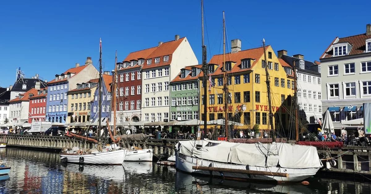 Copenhagen cityscape with Danish flag colors and historic buildings