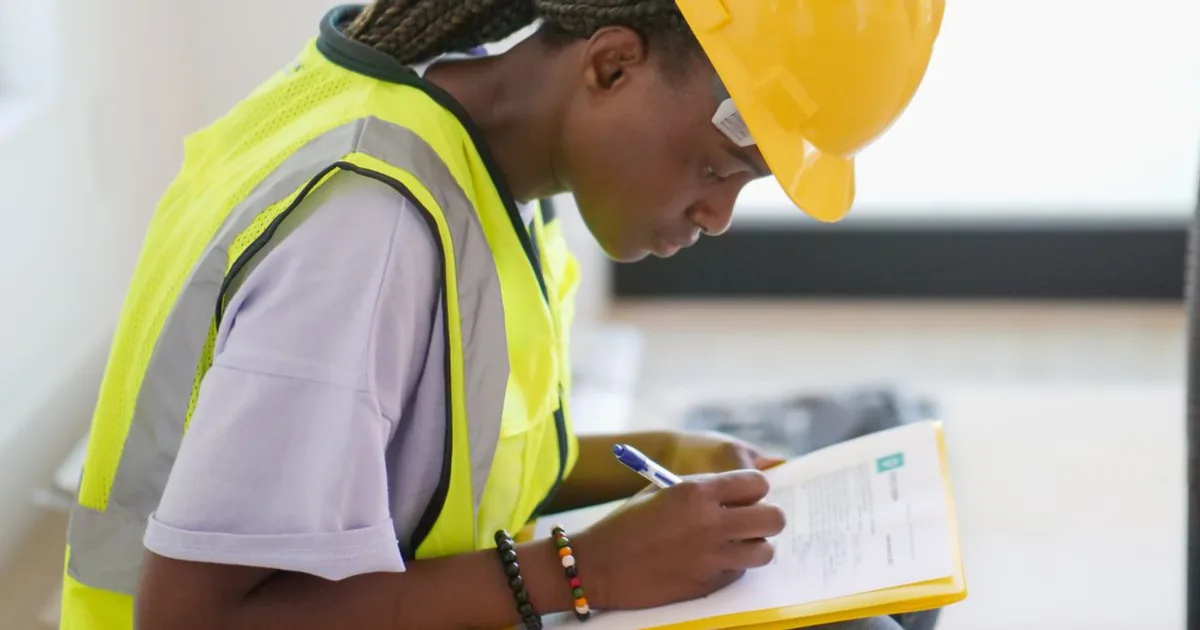 Safety professional reviewing a workplace risk assessment checklist on a clipboard