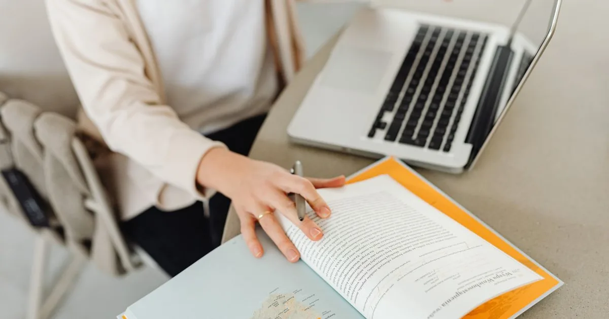 Person practicing Dutch speaking and inburgering modules on a laptop