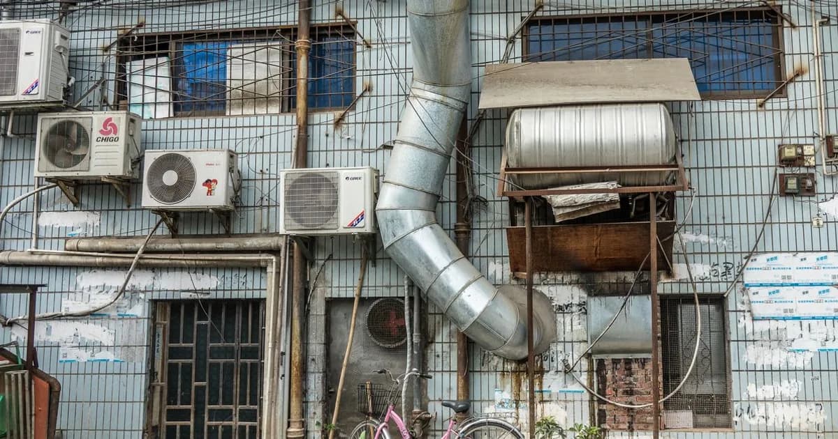 Commercial HVAC air handling unit and ductwork in a building mechanical room
